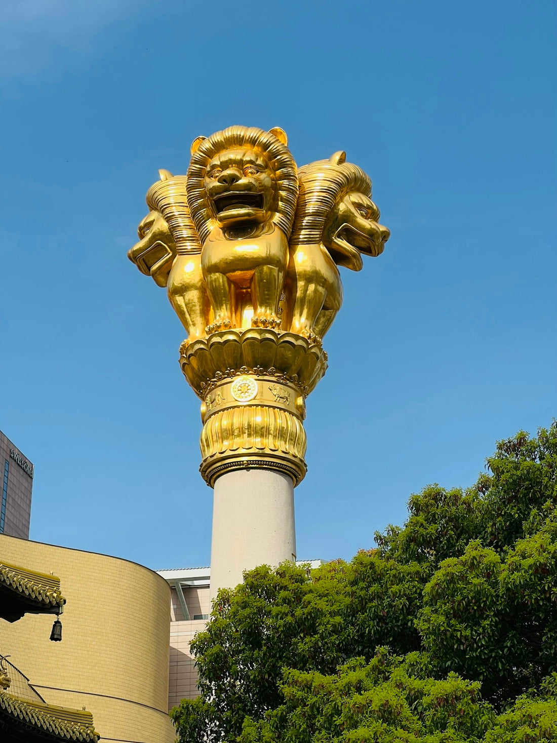 a golden statue of a lion on top of a building