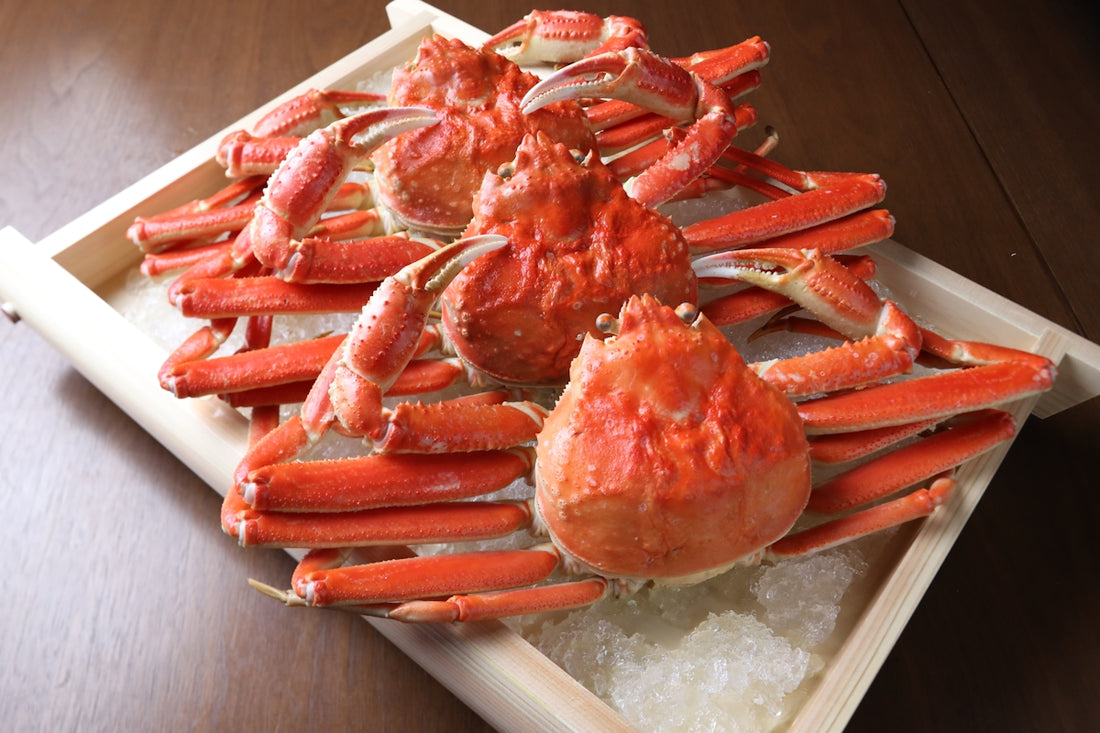 A tray of cooked crabs on ice on a table